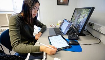 Student studying on multiple devices