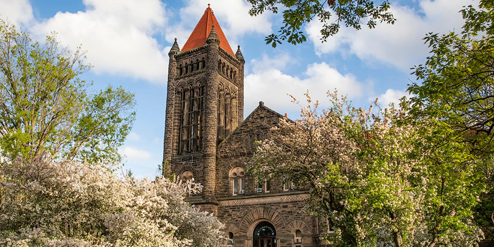 Altgeld Hall surrounded by spring growth.